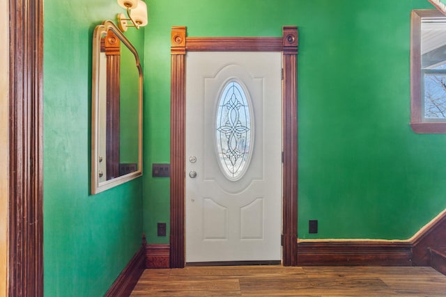 entryway with wood finished floors and baseboards