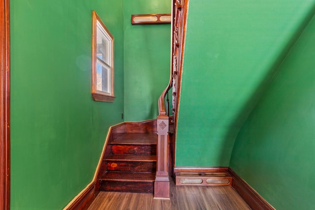 stairs featuring baseboards and wood finished floors