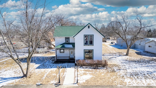 view of front facade with covered porch and metal roof