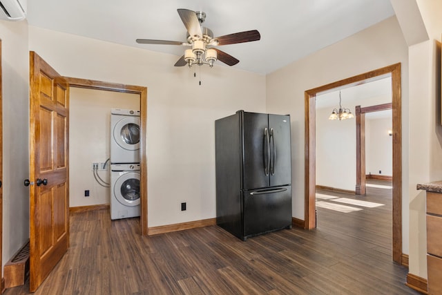 kitchen featuring a wall unit AC, dark wood-style floors, stacked washer / drying machine, and freestanding refrigerator