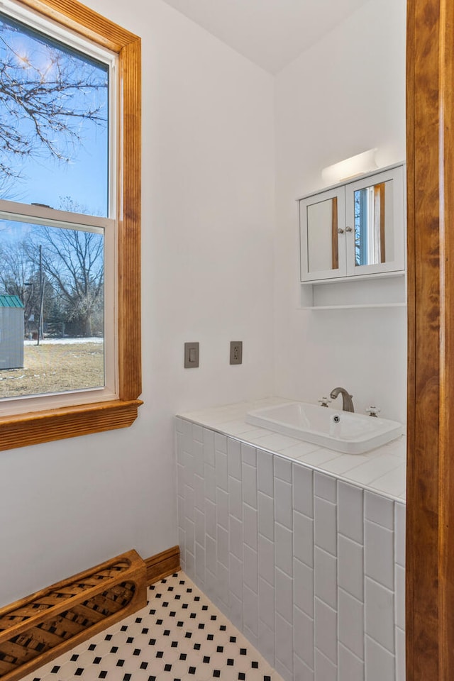 bathroom with a sink and tile patterned floors