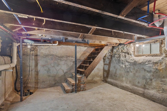 unfinished basement featuring stairs