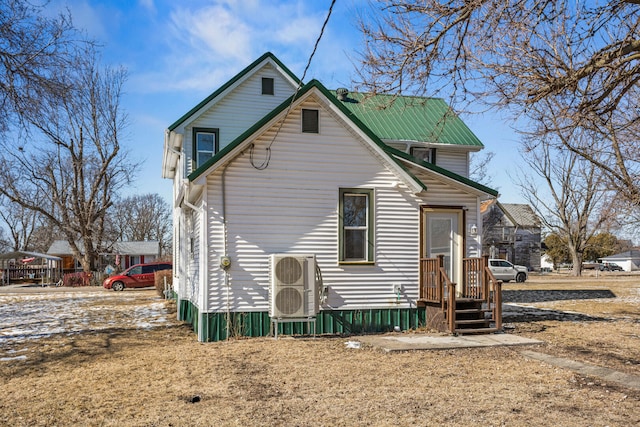 rear view of house featuring metal roof