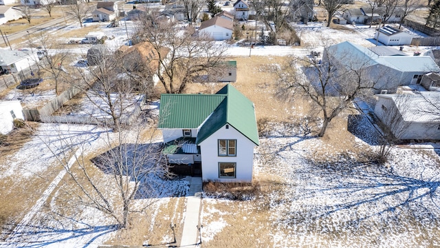 snowy aerial view with a residential view