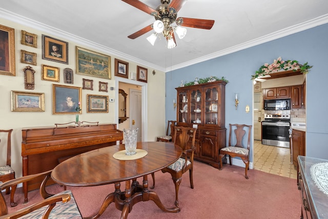 dining space featuring crown molding, light carpet, and ceiling fan