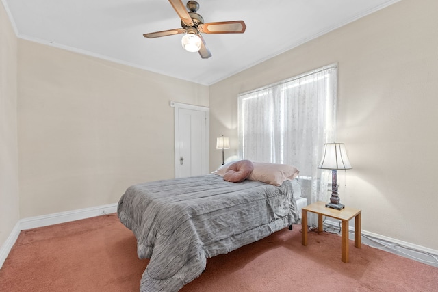 carpeted bedroom with ornamental molding and ceiling fan