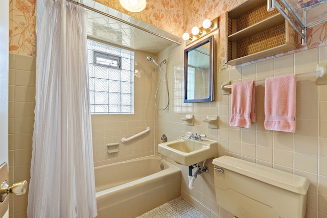 bathroom with tile walls, tile patterned floors, toilet, and shower / bathtub combination with curtain