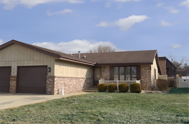 ranch-style home featuring an attached garage, driveway, a front lawn, and brick siding