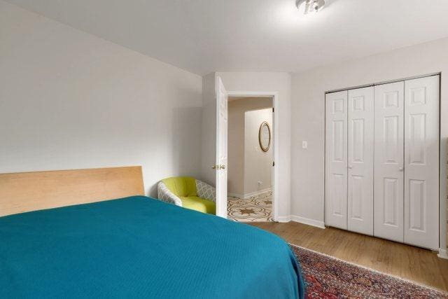 bedroom featuring hardwood / wood-style floors and a closet