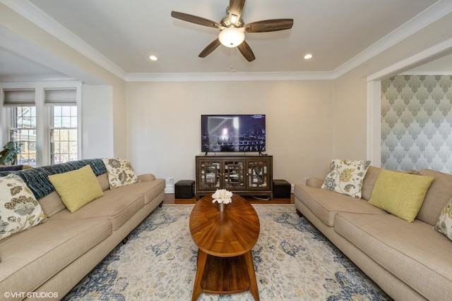 living room with ornamental molding and ceiling fan