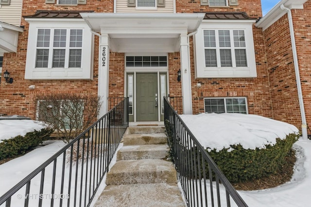 view of snow covered property entrance