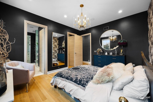 bedroom featuring an inviting chandelier and wood-type flooring