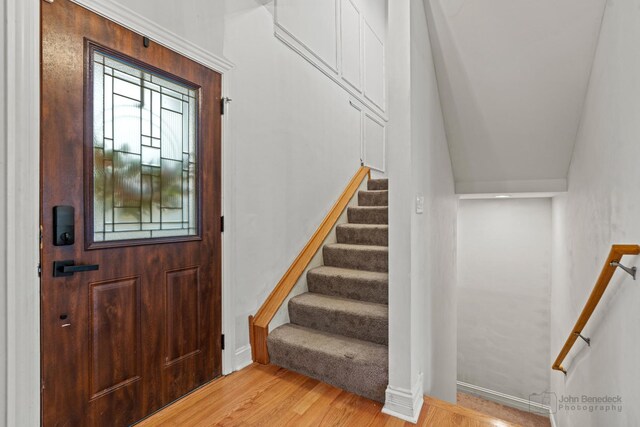 foyer with stairs and wood finished floors