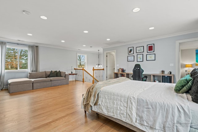 bedroom with recessed lighting, crown molding, and light wood-style flooring