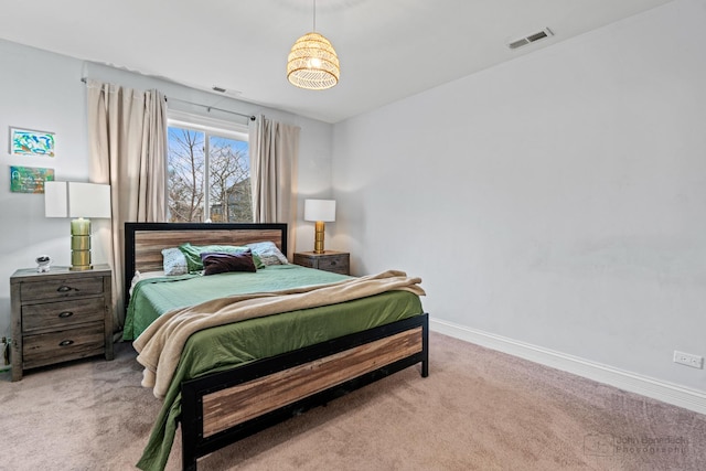 bedroom with carpet floors, baseboards, and visible vents