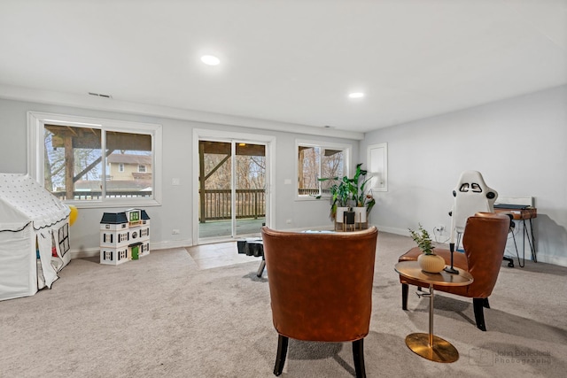 sitting room with carpet floors, a healthy amount of sunlight, baseboards, and visible vents