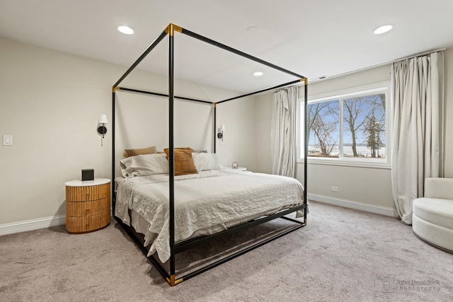 bedroom featuring light carpet, baseboards, and recessed lighting