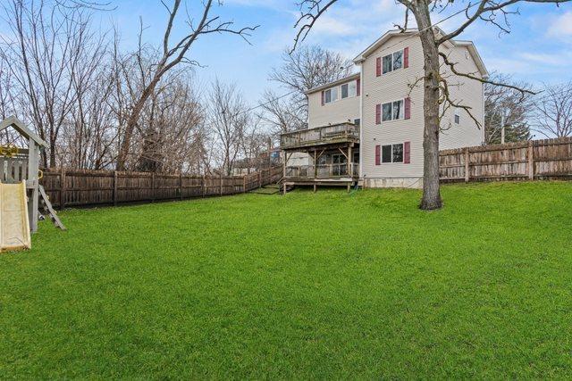 view of yard with a deck and a fenced backyard