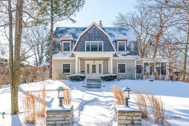 view of snow covered rear of property