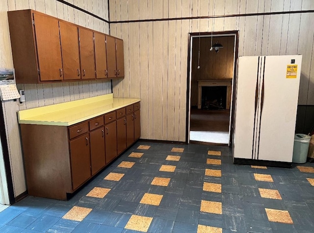 kitchen with wooden walls and white fridge