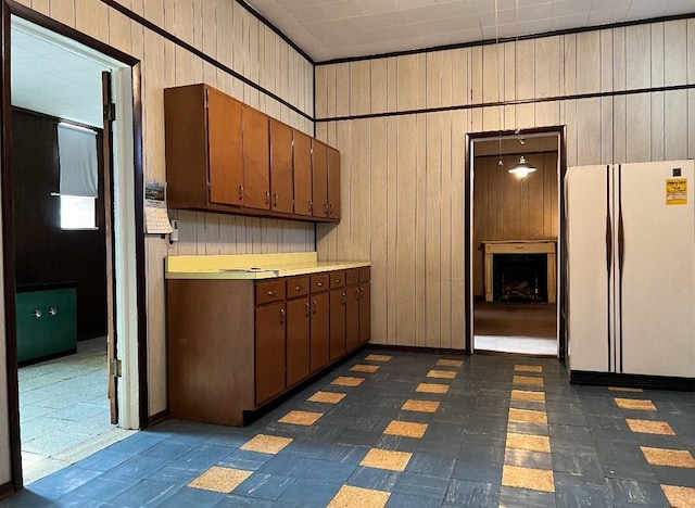 kitchen with white refrigerator and wood walls