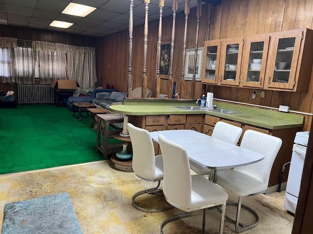 interior space featuring a paneled ceiling and wood walls