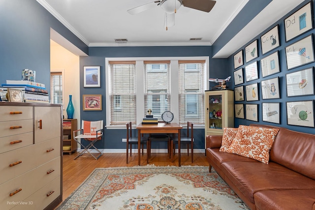 office space with ceiling fan, ornamental molding, and light hardwood / wood-style floors