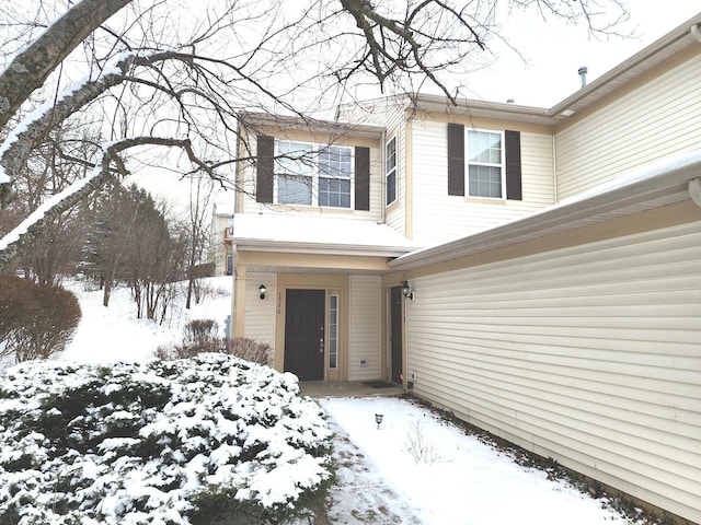 view of snow covered property entrance