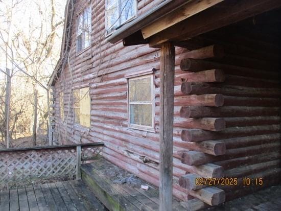 view of side of property featuring a wooden deck