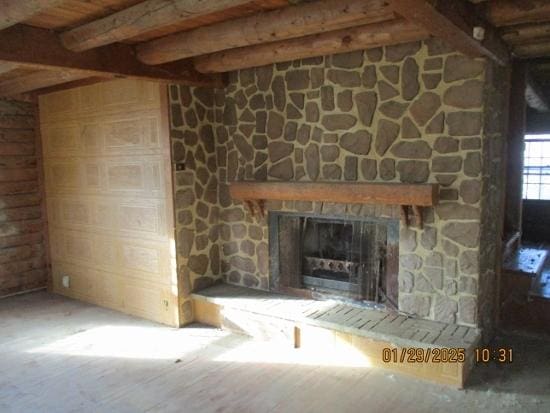 125 N Anderson Rd, New Lenox, IL 60451 - unfurnished living room with a fireplace, wood finished floors, and beam ceiling