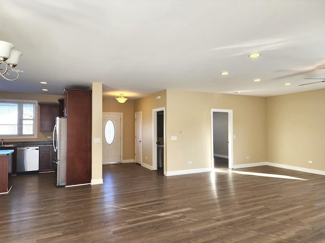 unfurnished living room with dark wood-style floors, recessed lighting, and baseboards