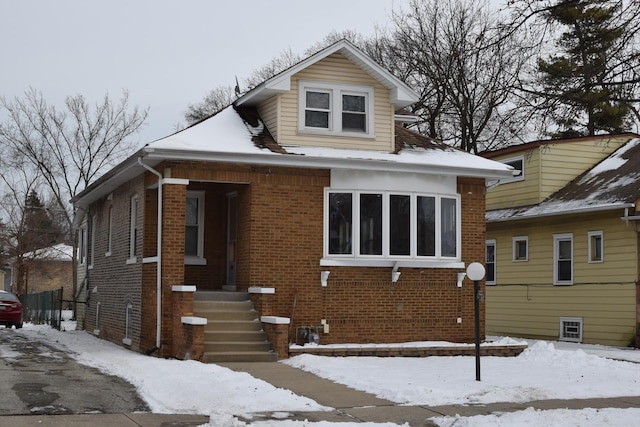 bungalow-style house with brick siding