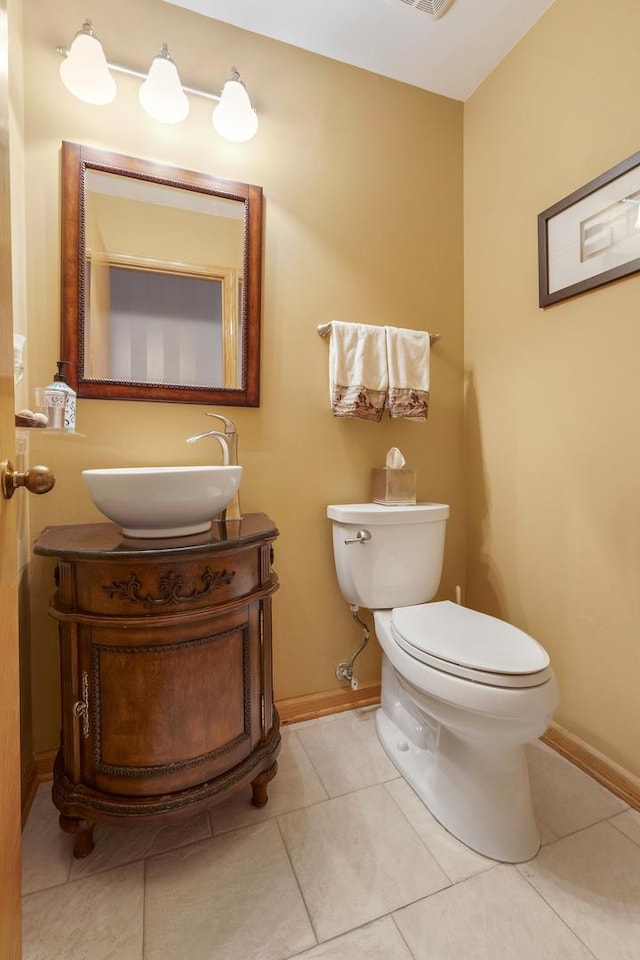 bathroom with vanity, toilet, and tile patterned flooring