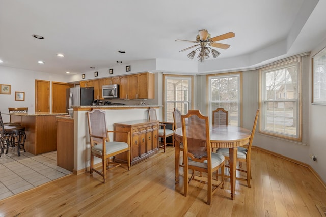 dining space featuring ceiling fan and light hardwood / wood-style flooring