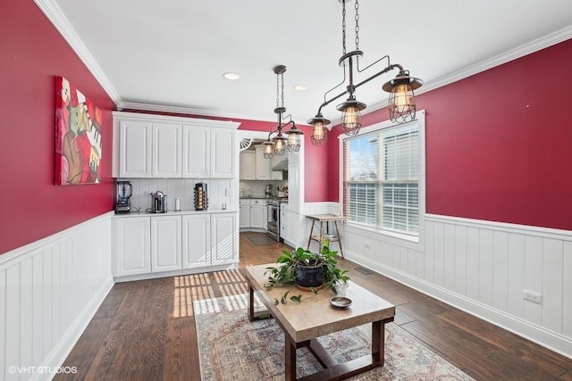 living room with crown molding and dark hardwood / wood-style flooring