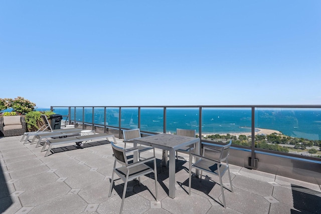 view of patio with a water view and a balcony