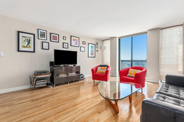 living room featuring light hardwood / wood-style flooring and floor to ceiling windows