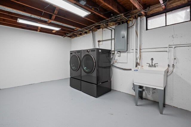 clothes washing area with laundry area, electric panel, and independent washer and dryer