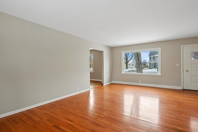 interior space featuring light wood-type flooring and baseboards