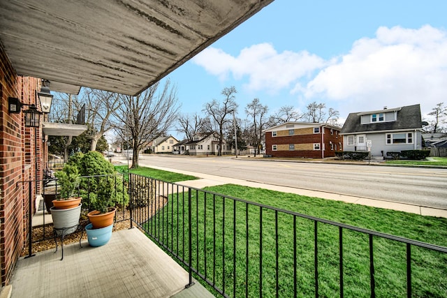 balcony featuring covered porch and a residential view