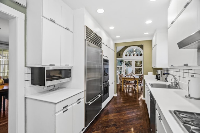 kitchen with light countertops, a sink, and white cabinetry