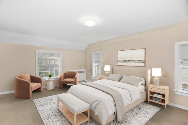 carpeted bedroom with radiator, baseboards, and vaulted ceiling