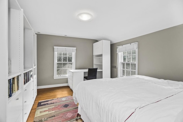 bedroom featuring baseboards and wood finished floors