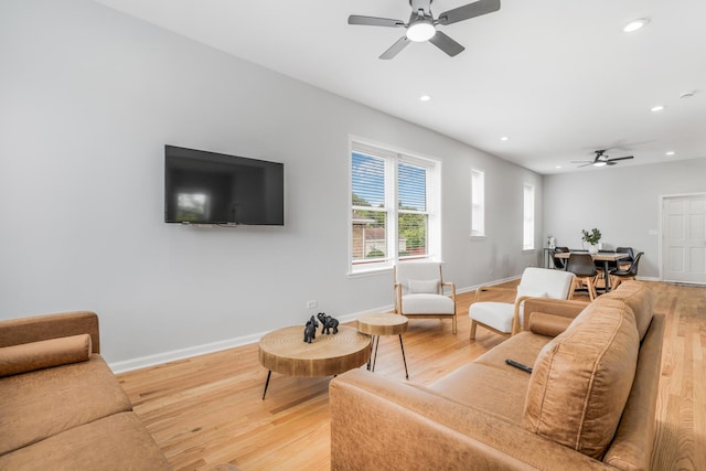 living room featuring hardwood / wood-style floors and ceiling fan