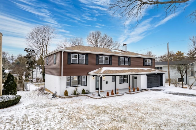 view of front of house with a garage and covered porch