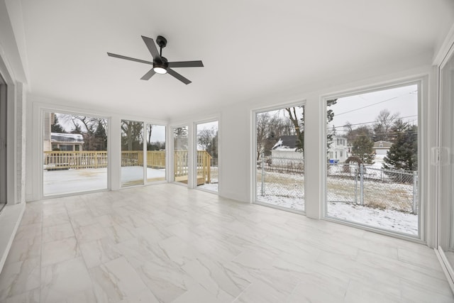 unfurnished sunroom with ceiling fan