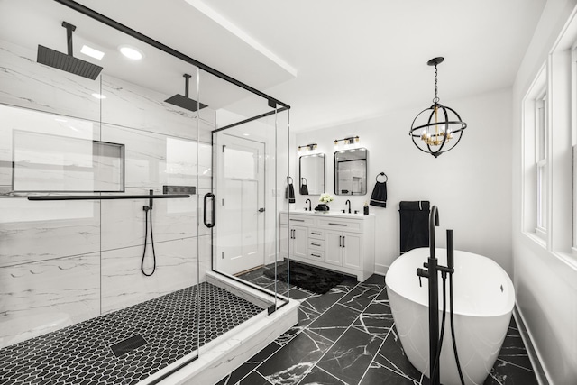 bathroom featuring plus walk in shower, vanity, and an inviting chandelier