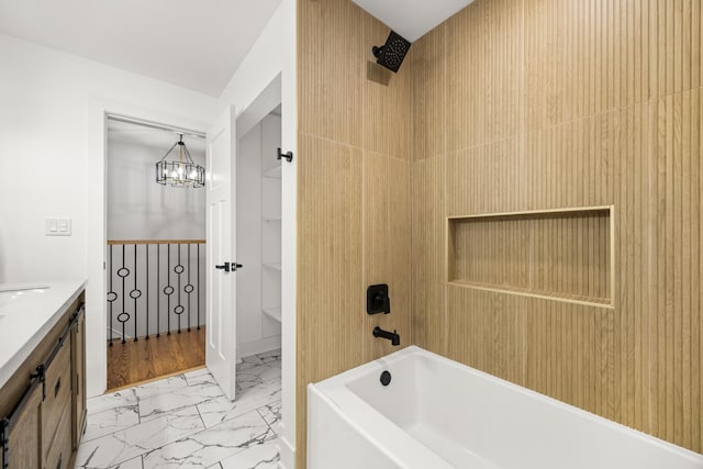 bathroom with shower / bath combination, vanity, and a notable chandelier