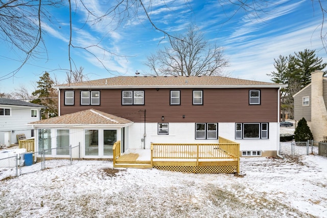 snow covered house with a deck