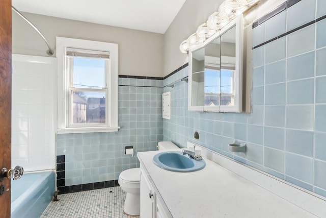 full bath with vanity, tile patterned floors, tile walls, and a healthy amount of sunlight